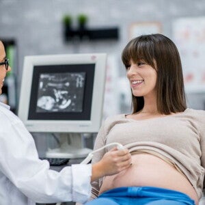 Calendario de visitas al doctor Mujer en consultorio tomando una cita prenatal