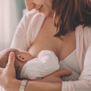 Smiling woman breastfeeding her baby Smiling woman breastfeeding her baby