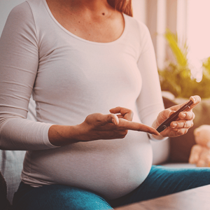 Pregnant woman doing a diabetes test with an epipen. Pregnant woman doing a diabetes test with an epipen.