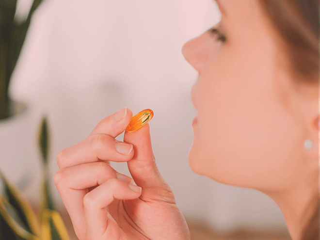 Side view of a woman taking a supplement Side view of a woman taking a supplement