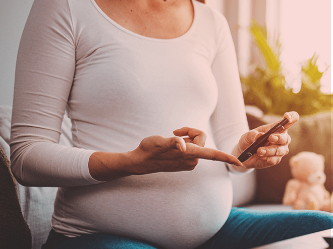 Pregnant woman doing a diabetes test with an epipen. Pregnant woman doing a diabetes test with an epipen.